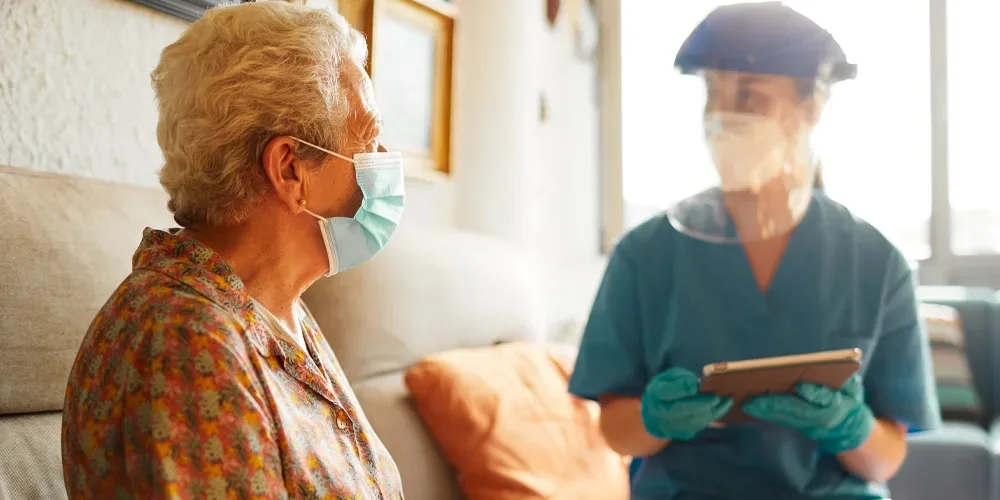 Nursing Home Resident in Mask with Nurse Nursing Home Resident in Mask with Nurse
